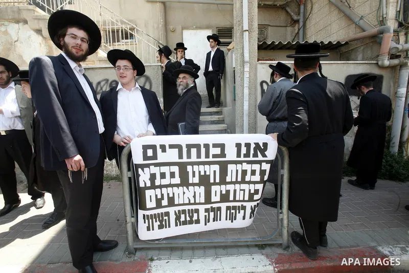 Ultra-Orthodox Jewish hold banners with slogans against involvement in the Israeli army during a protest in the west Jerusalem, on 01 July 2012. Photo by Mahfouz Abu Turk