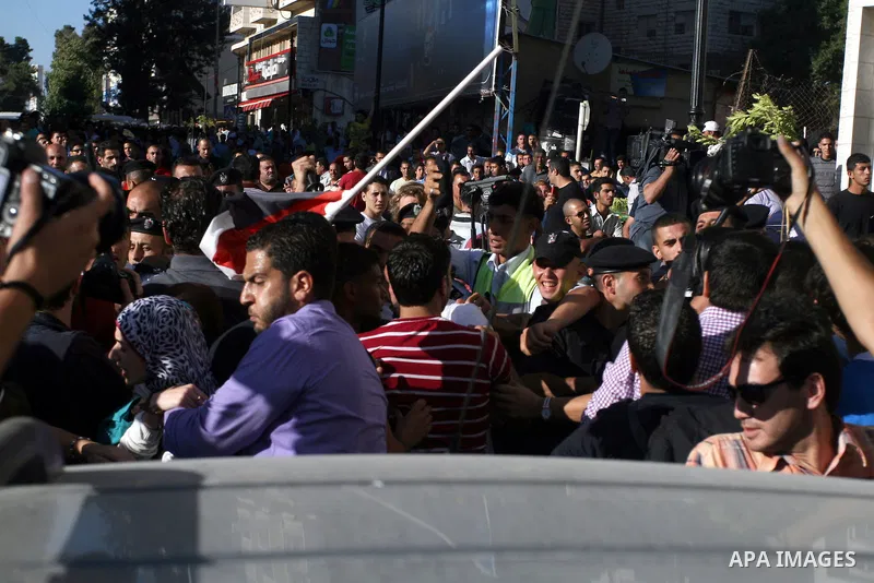 Palestinian Policemen block protesters from reaching the Palestinian presidential headquarters in the West Bank city of Ramallah, during a protest in the town, on 01 July 2012. Demonstrators protested against a scheduled...
