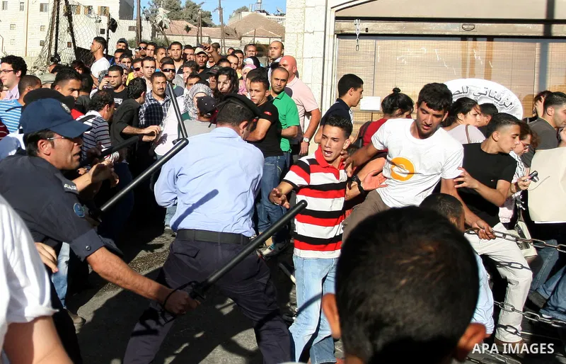 Palestinian Policemen block protesters from reaching the Palestinian presidential headquarters in the West Bank city of Ramallah, during a protest in the town, on 01 July 2012. Demonstrators protested against a scheduled...