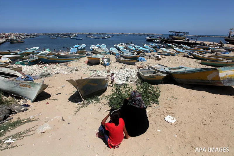 Palestinians sit in front of Gaza port on July 02, 2012.The European Union's envoy to the Palestinian Authority confirmed its support and allegiance to the people. Photo by Majdi Fathi