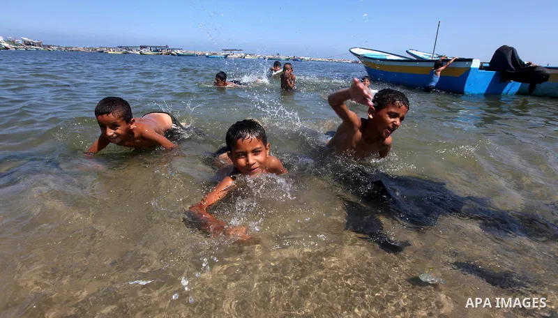 Palestinian children swim in Gaza port on July 02, 2012.The European Union's envoy to the Palestinian Authority confirmed its support and allegiance to the people. Photo by Majdi Fathi