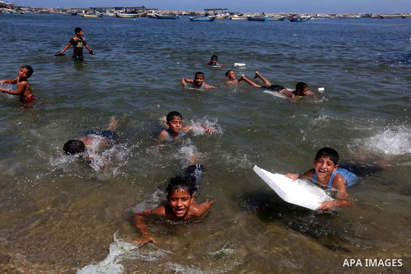 Palestinian children swim in Gaza port on July 02, 2012.The European Union's envoy to the Palestinian Authority confirmed its support and allegiance to the people. Photo by Majdi Fathi