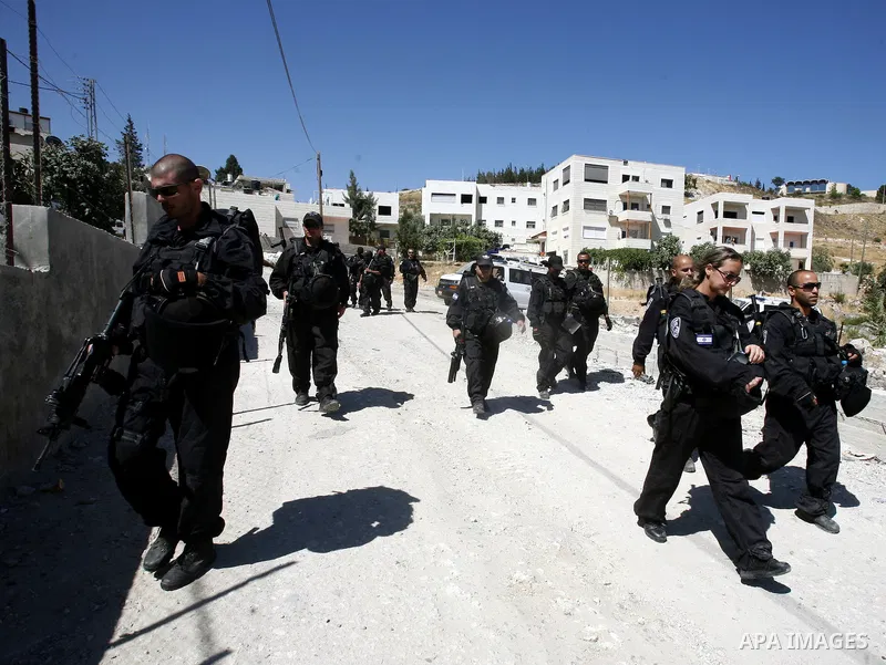 Israeli forces guard a destruction process of a Palestinian owned shop that was built without a permit in the neighbourhood of Issawiya, in the north of Jerusalem, on July 02, 2012. Israel revoked the residency of nearly...