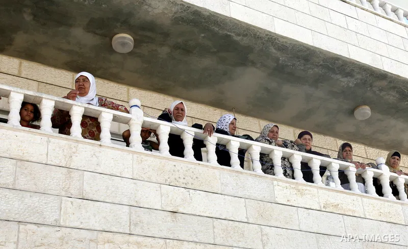Palestinian women look at a shop destroyed by Israeli forces on the pretext of building without a permit in the neighbourhood of Issawiya, in the north of Jerusalem, on July 02, 2012. Israel revoked the residency of near...