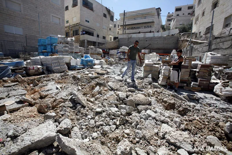 Palestinians check a shop destroyed by Israeli forces on the pretext of building without a permit in the neighbourhood of Issawiya, in the north of Jerusalem, on July 02, 2012. Israel revoked the residency of nearly 250,...