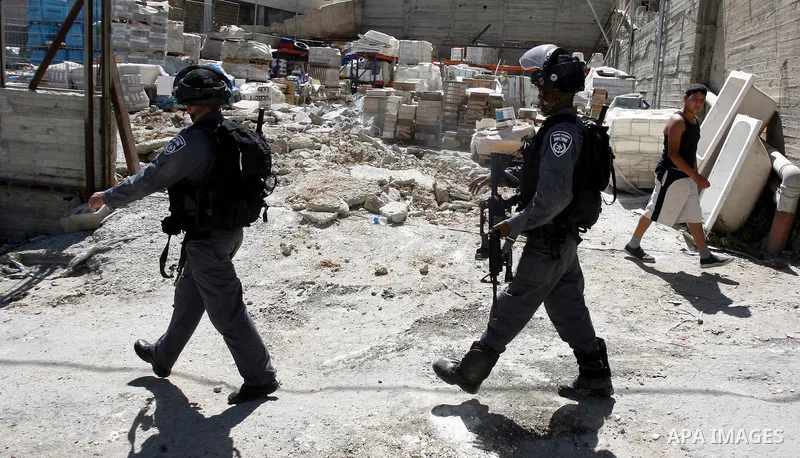 Israeli forces guard a destruction process of a Palestinian owned shop that was built without a permit in the neighbourhood of Issawiya, in the north of Jerusalem, on July 02, 2012. Israel revoked the residency of nearly...