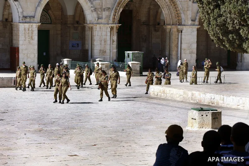 Israeli soldiers walk past the Al-Aqsa mosque compound, Islam's third holiest site, during a visit under Israeli police protection in Jerusalem's Old City on July 02, 2012. Photo by Mahfouz Abu Turk