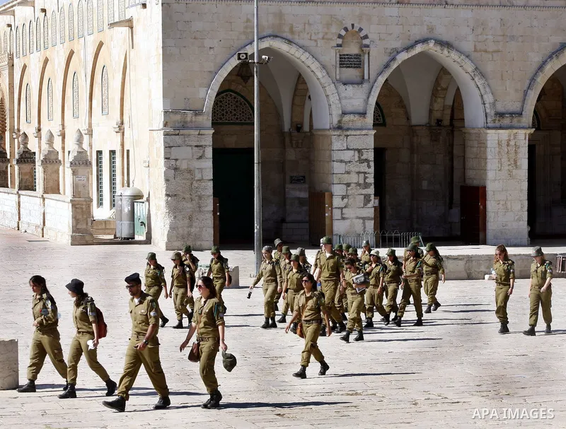 Israeli soldiers walk past the Al-Aqsa mosque compound, Islam's third holiest site, during a visit under Israeli police protection in Jerusalem's Old City on July 02, 2012. Photo by Mahfouz Abu Turk