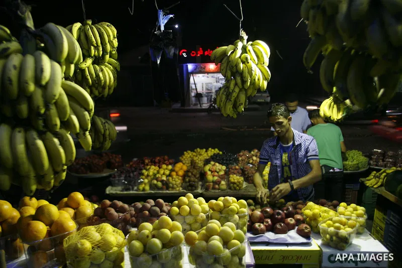 A Palestinian man sells fruits at a popular market in Rafah in southern Gaza on July 03, 2012. Photo by Eyad Al Baba