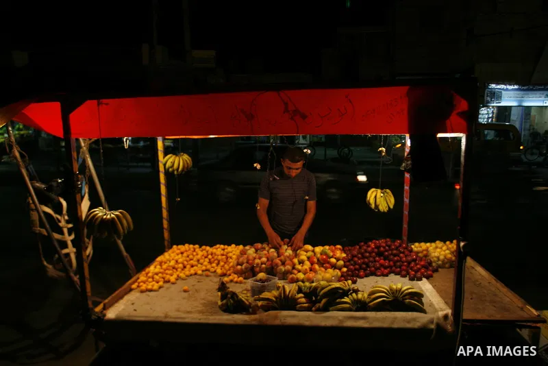 A Palestinian man sells fruits at a popular market in Rafah in southern Gaza on July 03, 2012. Photo by Eyad Al Baba
