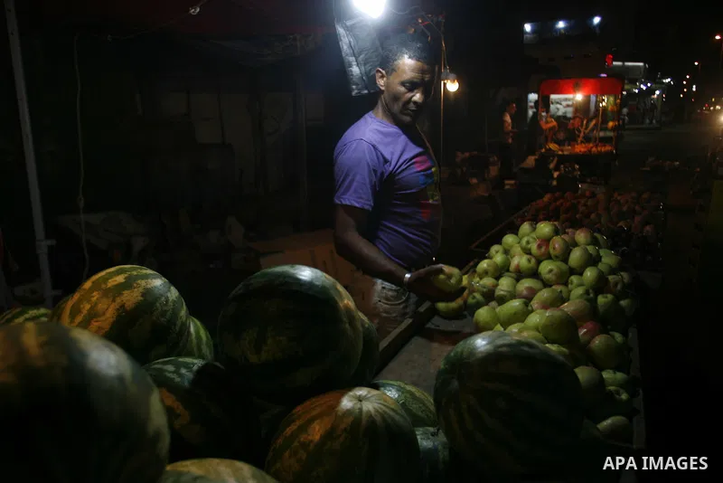 A Palestinian man sells fruits at a popular market in Rafah in southern Gaza on July 03, 2012. Photo by Eyad Al Baba