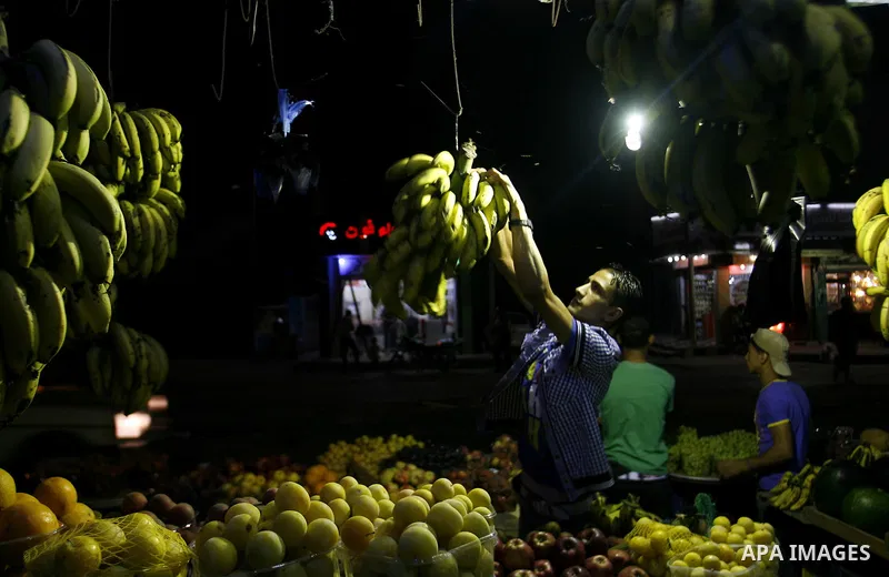 A Palestinian man sells fruits at a popular market in Rafah in southern Gaza on July 03, 2012. Photo by Eyad Al Baba