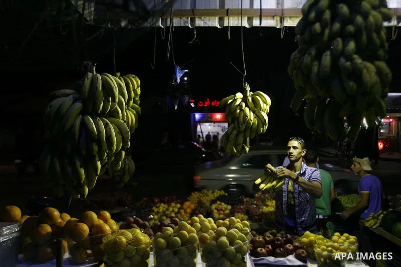 A Palestinian man sells fruits at a popular market in Rafah in southern Gaza on July 03, 2012. Photo by Eyad Al Baba