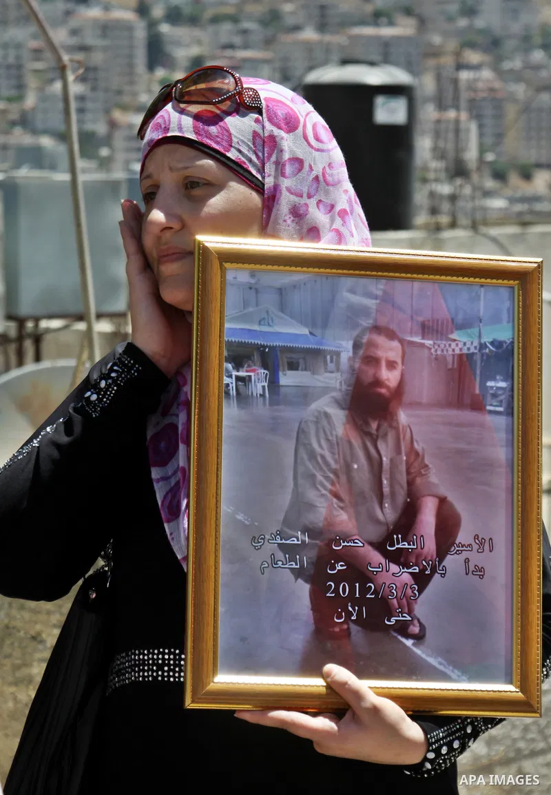 Palestinians gather during a protest in front of the Red Cross' offices in West Bank city of Nablus calling of release of palestinian prisoners on July, 04, 2012. Photo by Nedal Eshtayah