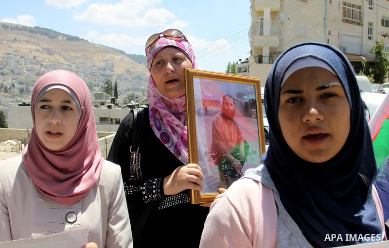 Palestinians gather during a protest in front of the Red Cross' offices in West Bank city of Nablus calling of release of palestinian prisoners on July, 04, 2012. Photo by Nedal Eshtayah