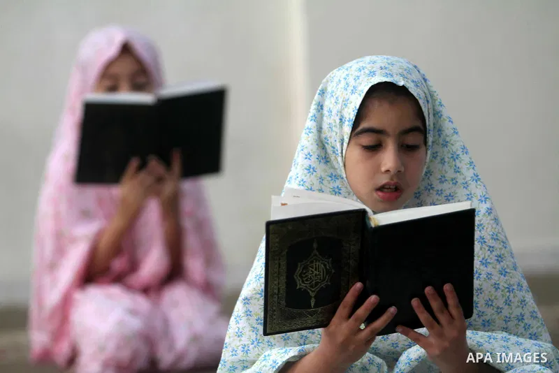 Palestinian girls read the Koran at a summer camp in the Gaza Strip, 04 July 2012. About 20,000 students, both male and female, study under the tuition of 1,200 teachers at the camp. Hamas usually isolates boys and girls...