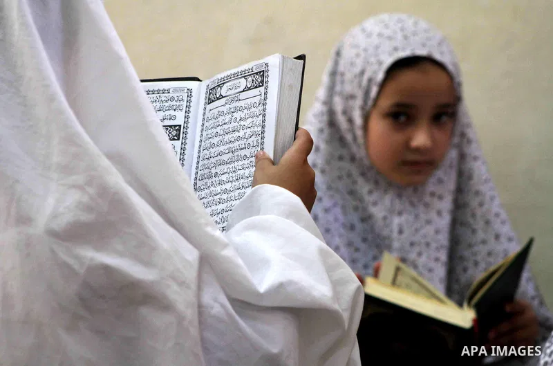 Palestinian girls read the Koran at a summer camp in the Gaza Strip, 04 July 2012. About 20,000 students, both male and female, study under the tuition of 1,200 teachers at the camp. Hamas usually isolates boys and girls...