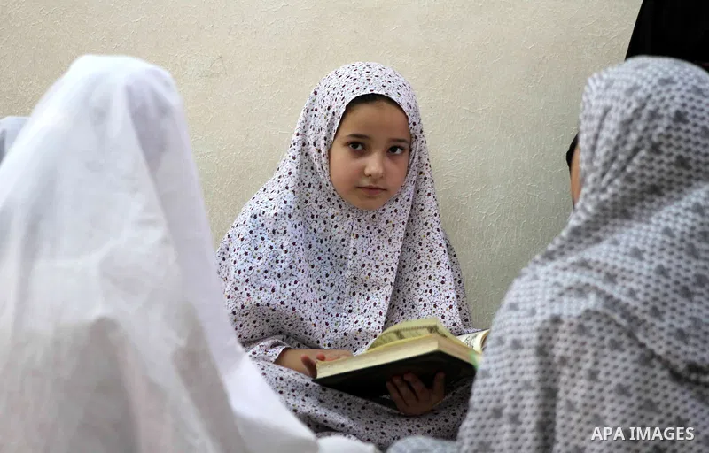 Palestinian girls read the Koran at a summer camp in the Gaza Strip, 04 July 2012. About 20,000 students, both male and female, study under the tuition of 1,200 teachers at the camp. Hamas usually isolates boys and girls...