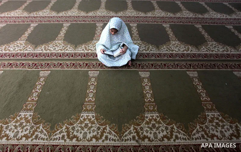 Palestinian girls read the Koran at a summer camp in the Gaza Strip, 04 July 2012. About 20,000 students, both male and female, study under the tuition of 1,200 teachers at the camp. Hamas usually isolates boys and girls...