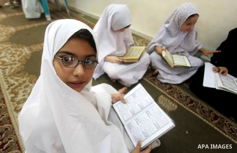 Palestinian girls read the Koran at a summer camp in the Gaza Strip, 04 July 2012. About 20,000 students, both male and female, study under the tuition of 1,200 teachers at the camp. Hamas usually isolates boys and girls...