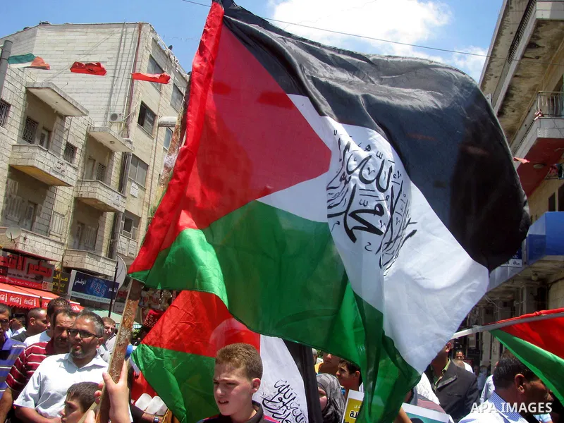 Palestinians hold national flags and pictures of political prisoners in the Palestinian Authority jails during a demonstration demands to release them, in the West Bank city of Ramallah, on 04 July 2012. Photo by Issam R...
