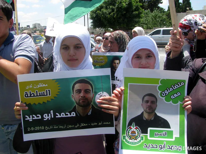 Palestinians hold national flags and pictures of political prisoners in the Palestinian Authority jails during a demonstration demands to release them, in the West Bank city of Ramallah, on 04 July 2012. Photo by Issam R...