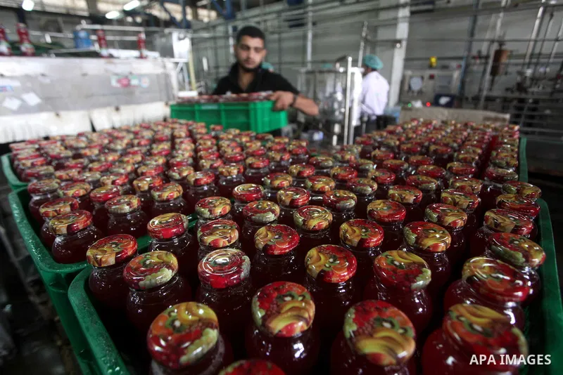 Palestinian workers bottle fruit juice at Juice Factory in Gaza City on July 5, 2011. it depends on citrus and fruit that are widely planted in Gaza Strip. Photo by Ashraf Amra