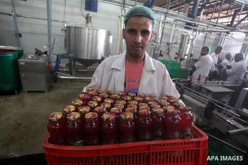 Palestinian workers bottle fruit juice at Juice Factory in Gaza City on July 5, 2011. it depends on citrus and fruit that are widely planted in Gaza Strip. Photo by Ashraf Amra