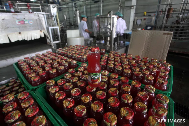 Palestinian workers bottle fruit juice at Juice Factory in Gaza City on July 5, 2011. it depends on citrus and fruit that are widely planted in Gaza Strip. Photo by Ashraf Amra
