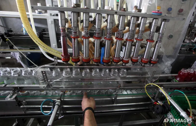 Palestinian workers bottle fruit juice at Juice Factory in Gaza City on July 5, 2011. it depends on citrus and fruit that are widely planted in Gaza Strip. Photo by Ashraf Amra