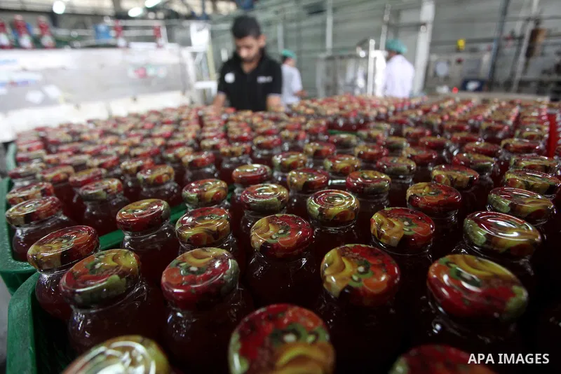 Palestinian workers bottle fruit juice at Juice Factory in Gaza City on July 5, 2011. it depends on citrus and fruit that are widely planted in Gaza Strip. Photo by Ashraf Amra