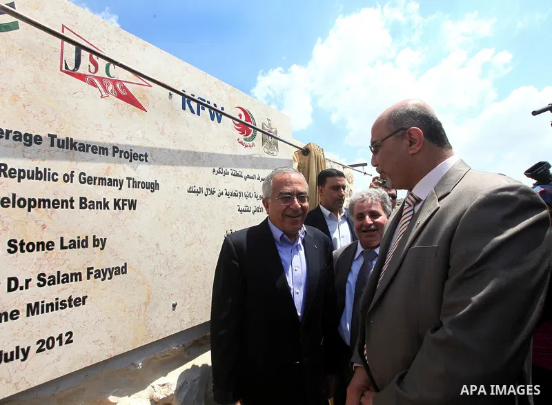 Palestinian Prime Minister Salam Fayyad puts the foundation stone of sanitation regional project in Wad al-Zumar in the West Bank city of Tulkarm on 05 July 2012. Photo by Mustafa Abu Dayeh