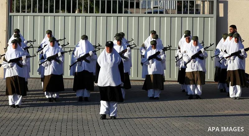 Female Hamas's police officers stand to attention during a ceremony in Gaza City on July 05, 2012. Hamas has governed the Gaza Strip since June 2007, after it won a majority of seats in the Palestinian Parliament in the...