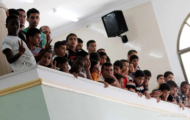 Palestinians listen to Palestinian Prime Minister in Gaza Ismail Haniyeh speech during Friday prayer in Deir al-Balah in the center of Gaza Strip on 06 July 2012. A Palestinian official said Thursday, July 5, 2012 that G...