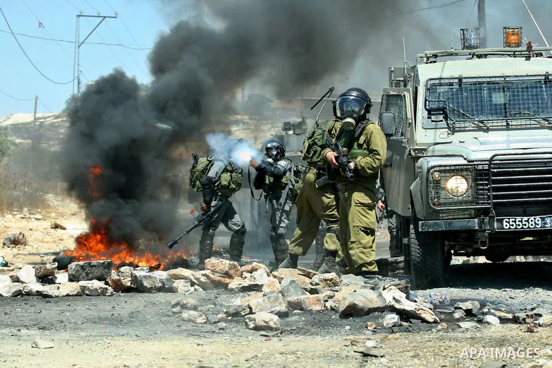 Israeli border policemen fire teargas towards Palestinian demonstrators during a protest against the expansion of the nearby Jewish settlement of Kdumim, in the northern West Bank village of Kufr Qaddum, on 06 July 2012....