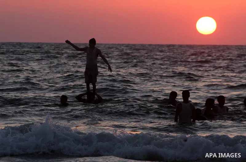A Palestinian youth jumps into the Mediterranean sea on the beach of Gaza City, on July 06, 2012. Photo by Ashraf Amra