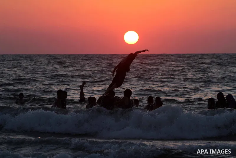 A Palestinian youth jumps into the Mediterranean sea on the beach of Gaza City, on July 06, 2012. Photo by Ashraf Amra