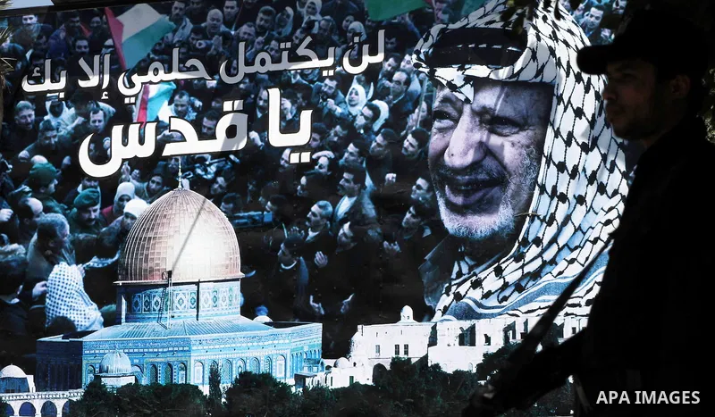 A huge poster of late Palestinian leader Yasser Arafat with al-Aqsa mosque in Gaza City on July 7, 2012. The Palestinian National Authority (PNA) has agreed to exhume late President Yasser Arafat's body for examination u...