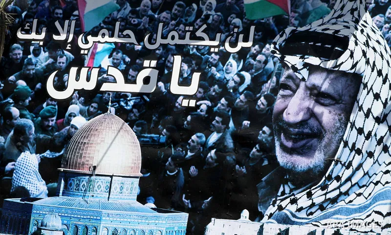 A huge poster of late Palestinian leader Yasser Arafat with al-Aqsa mosque in Gaza City on July 7, 2012. The Palestinian National Authority (PNA) has agreed to exhume late President Yasser Arafat's body for examination u...