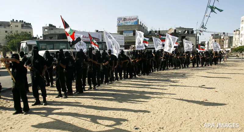 Militants from the Palestinian al-Ahrar Brigade march during a ceremony for the fifth anniversary of their inception in the southern Gaza Strip town of Rafah on July 7, 2012.. Photo by Eyad Al Baba.