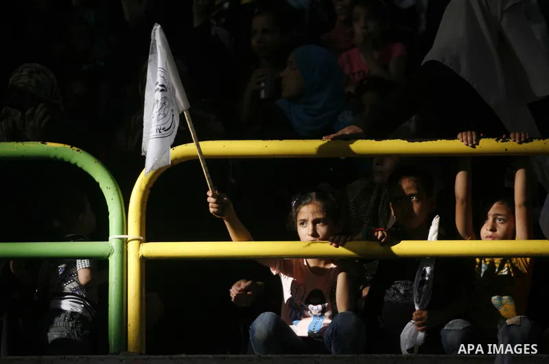 Palestinians from the Palestinian al-Ahrar Brigade celebrate during a ceremony for the fifth anniversary of their inception in the southern Gaza Strip town of Rafah on July 7, 2012. Photo by Eyad Al Baba