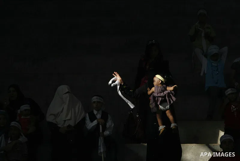 Palestinians from the Palestinian al-Ahrar Brigade celebrate during a ceremony for the fifth anniversary of their inception in the southern Gaza Strip town of Rafah on July 7, 2012. Photo by Eyad Al Baba