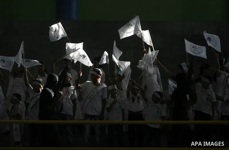 Palestinians from the Palestinian al-Ahrar Brigade celebrate during a ceremony for the fifth anniversary of their inception in the southern Gaza Strip town of Rafah on July 7, 2012. Photo by Eyad Al Baba
