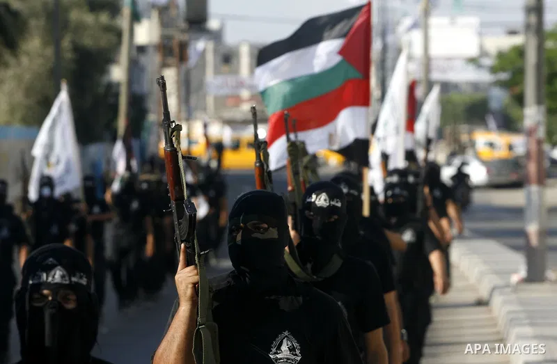 Militants from the Palestinian al-Ahrar Brigade march during a ceremony for the fifth anniversary of their inception in the southern Gaza Strip town of Rafah on July 7, 2012.. Photo by Eyad Al Baba. Photo by Eyad Al Baba