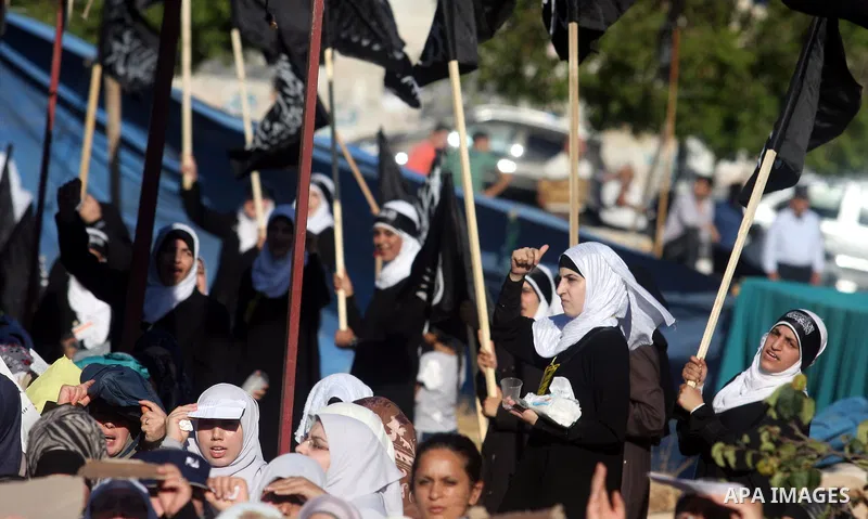 Palestinian supporters of Hizb ut-Tahrir or the Islamic Liberation Party, chant slogans and wave black and white flags with the religous writing "There is no God but God, and Mohammed is his prophet" during a rally in th...