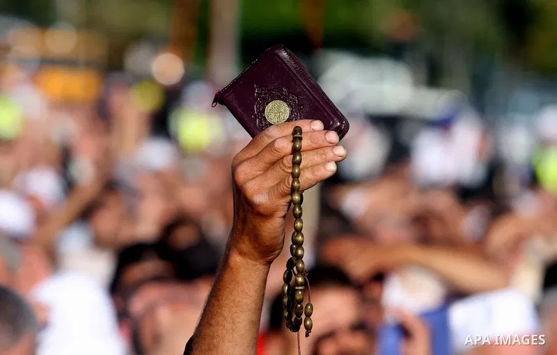 Palestinian supporters of Hizb ut-Tahrir or the Islamic Liberation Party, chant slogans and wave black and white flags with the religous writing "There is no God but God, and Mohammed is his prophet" during a rally in th...