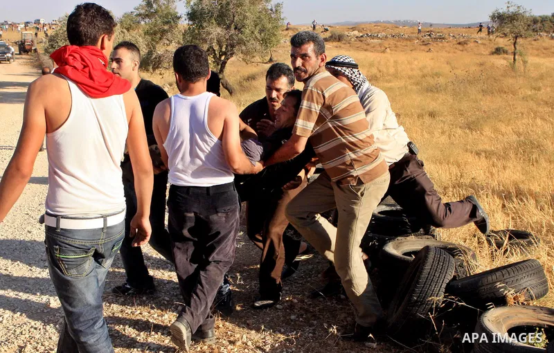 Palestinians run from tear gas fired by Israeli soldiers after two shepherds from the village of Aqraba, south of the city of Nablus in the Israeli occupied West Bank were allegedly attacked by Jewish settlers from the I...