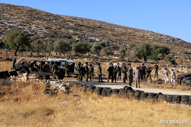 Israeli soldiers fire tear gas to disperse Palestinians after two shepherds from the village of Aqraba, south of the city of Nablus in the Israeli occupied West Bank were allegedly attacked by Jewish settlers from the Is...