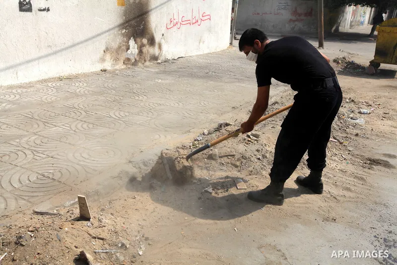 Palestinian officers participate in cleaning streets during a campaign organized by ministry of Labor, in Gaza city on July 09 2012. Photo by Majdi Fathi