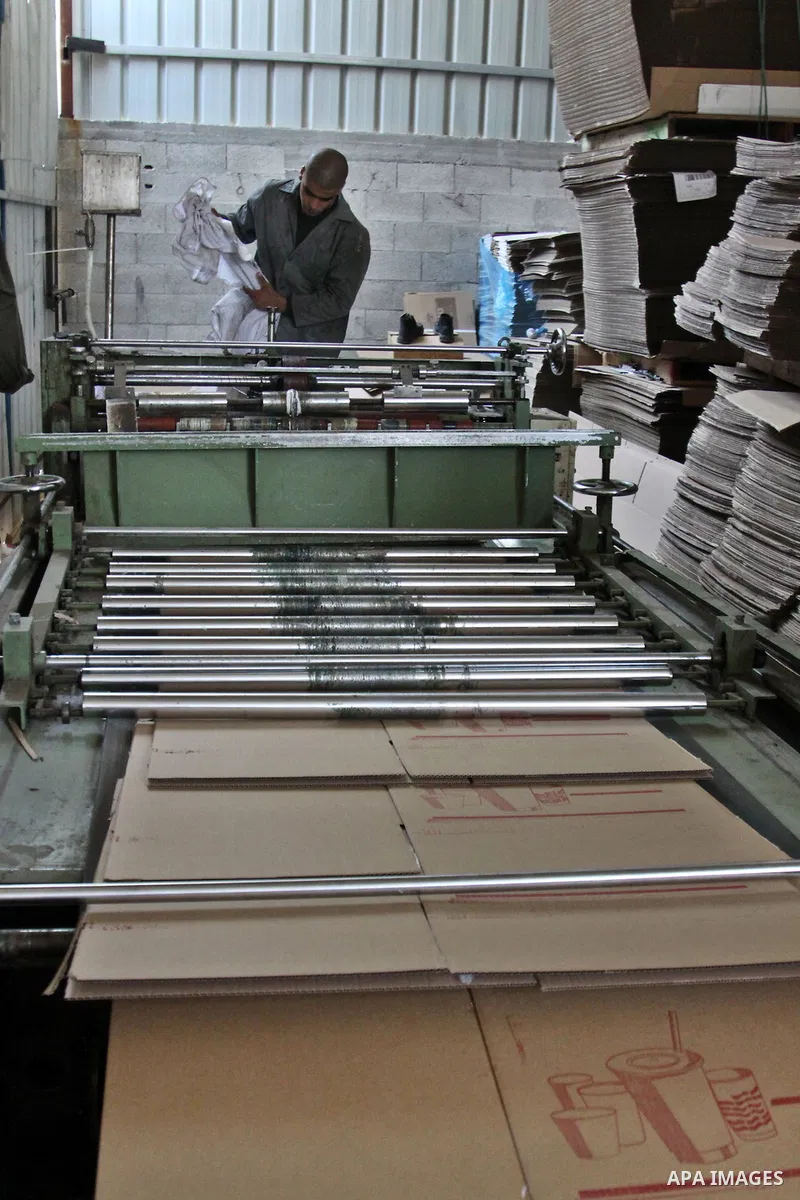 Palestinian labourers work at a factory for making a carton in the West Bank city of Nablus on July 09, 2012. Photo by Nedal Eshtayah